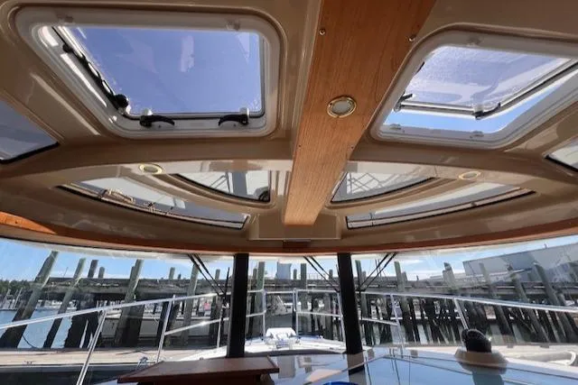 Windless Yacht Photos Pics Interior view of 2016 Ranger Tugs R-29 S Tug with skylights and marina backdrop.