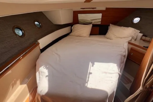 Windless Yacht Photos Pics Cozy cabin interior of 2016 Ranger Tugs R-29 S Tug with bed and portholes.