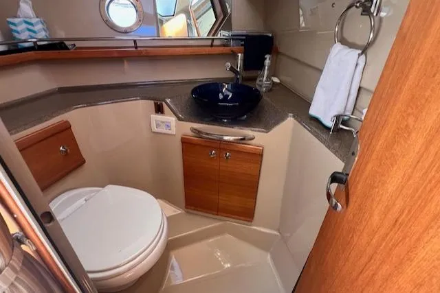 Windless Yacht Photos Pics 2016 Ranger Tugs R-29 S Tug bathroom with modern fixtures and wooden cabinetry.