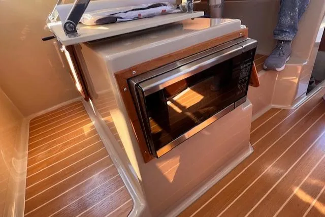 Windless Yacht Photos Pics 2016 Ranger Tugs R-29 S Tug interior with microwave and wood flooring.