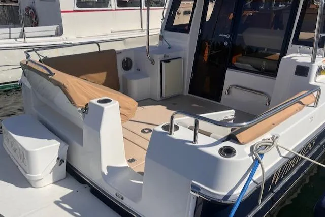 Windless Yacht Photos Pics 2016 Ranger Tugs R-29 S Tug boat with spacious deck and seating area.