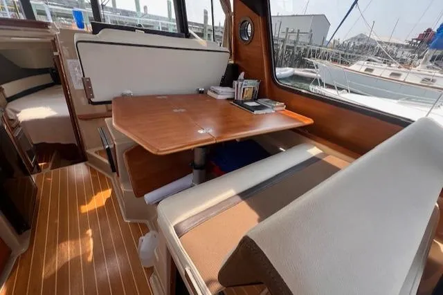 Windless Yacht Photos Pics Interior of 2016 Ranger Tugs R-29 S Tug with wooden table and seating.