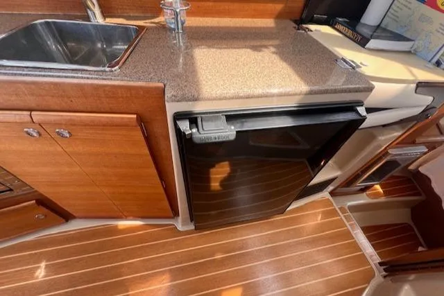 Windless Yacht Photos Pics 2016 Ranger Tugs R-29 S Tug kitchen with wood cabinetry and compact fridge.