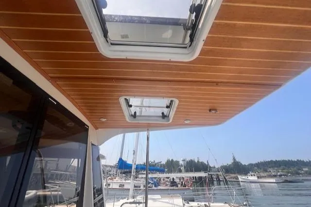 Windless Yacht Photos Pics 2016 Ranger Tugs R-29 S Tug with wooden ceiling and skylights, docked at marina.