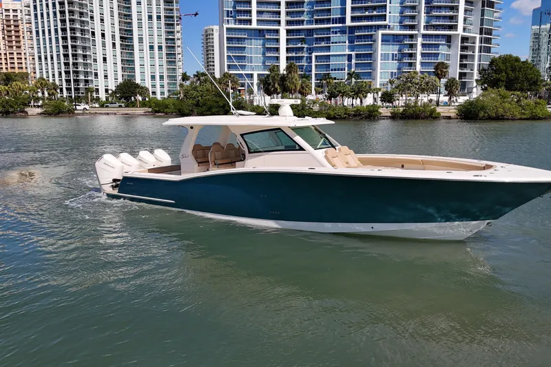 Perfect Season Yacht Photos Pics 2024 Scout 425 LXF boat cruising near modern city skyline.
