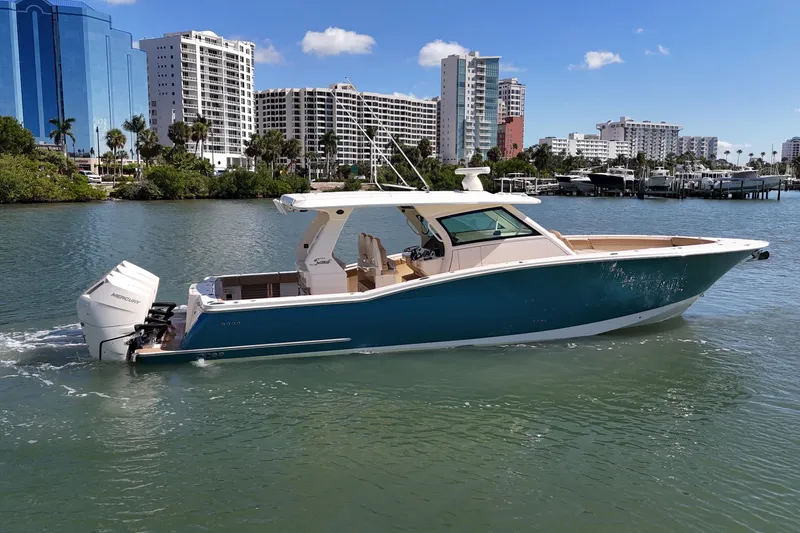 Perfect Season Yacht Photos Pics 2024 Scout 425 LXF boat cruising in a scenic urban waterfront setting.