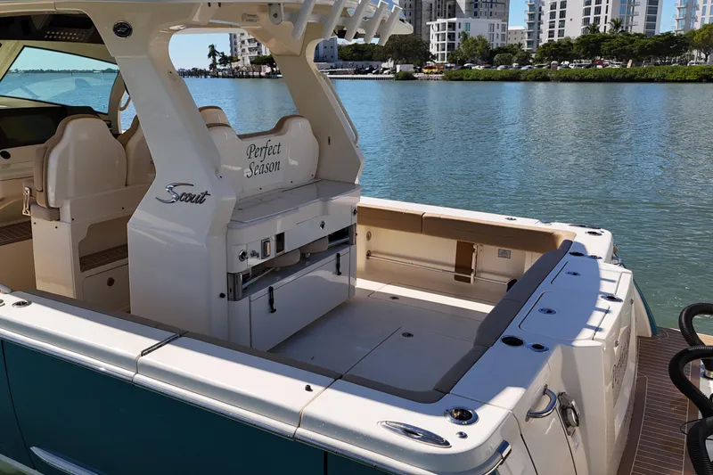 Perfect Season Yacht Photos Pics 2024 Scout 425 LXF boat with luxurious seating and scenic waterfront view.