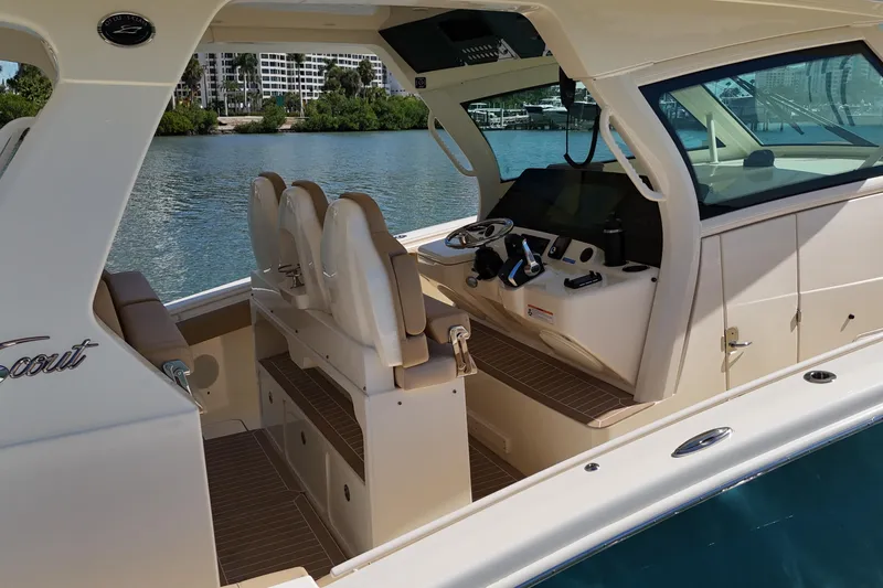 Perfect Season Yacht Photos Pics 2024 Scout 425 LXF boat interior with helm, seating, and water view.