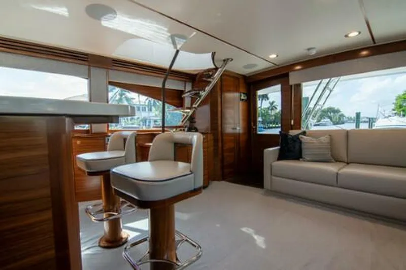 Caballo Grande Yacht Photos Pics Luxurious interior of 2024 Viking 68 Enclosed Bridge yacht with modern seating and elegant design.