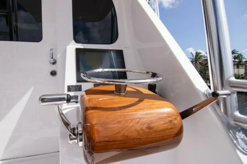 Caballo Grande Yacht Photos Pics 2024 Viking 68 Enclosed Bridge helm with wooden steering wheel and control panel.