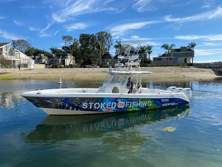 Stoked On Fishing Yacht Photos Pics 2008 Everglades 355 Center Console boat on water, vibrant "Stoked on Fishing" design.