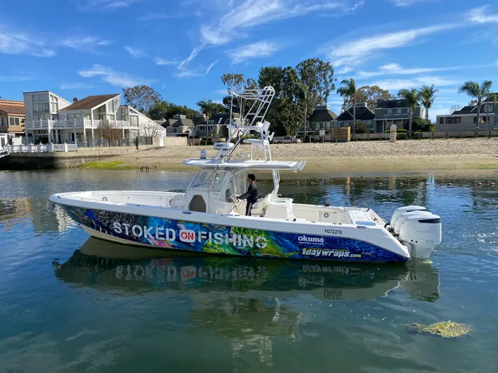Stoked On Fishing Yacht Photos Pics 2008 Everglades 355 Center Console boat on water, vibrant "Stoked on Fishing" design.