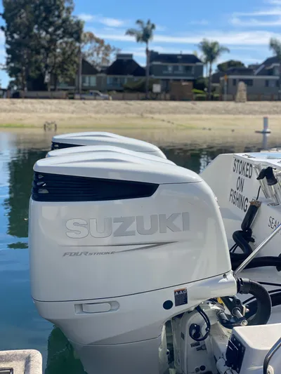 Stoked On Fishing Yacht Photos Pics 2008 Everglades 355 Center Console with Suzuki outboard engines, docked by waterfront homes.