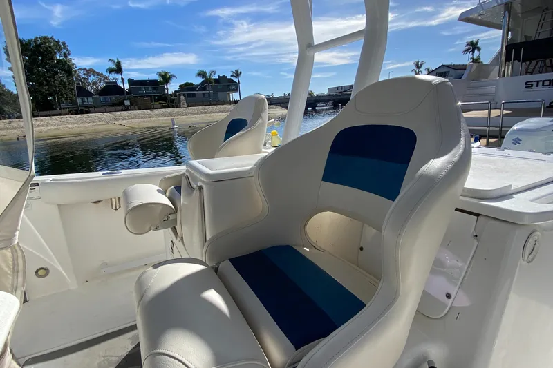 Stoked On Fishing Yacht Photos Pics 2008 Everglades 355 Center Console boat with white and blue seating, docked by the water.