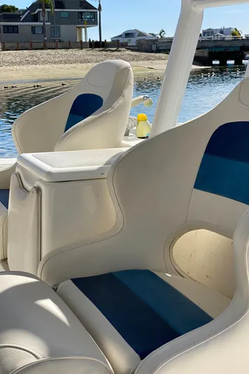 Stoked On Fishing Yacht Photos Pics 2008 Everglades 355 Center Console boat with blue and white seating by the water.