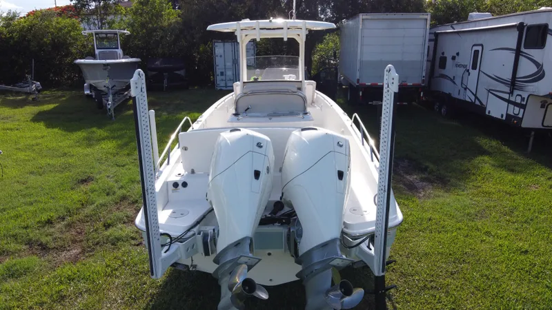  Yacht Photos Pics 2020 Boston Whaler 270 Dauntless boat with dual engines, parked on grass.