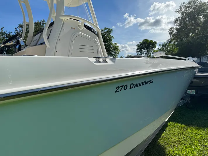  Yacht Photos Pics 2020 Boston Whaler 270 Dauntless boat, side view, outdoors on grass.