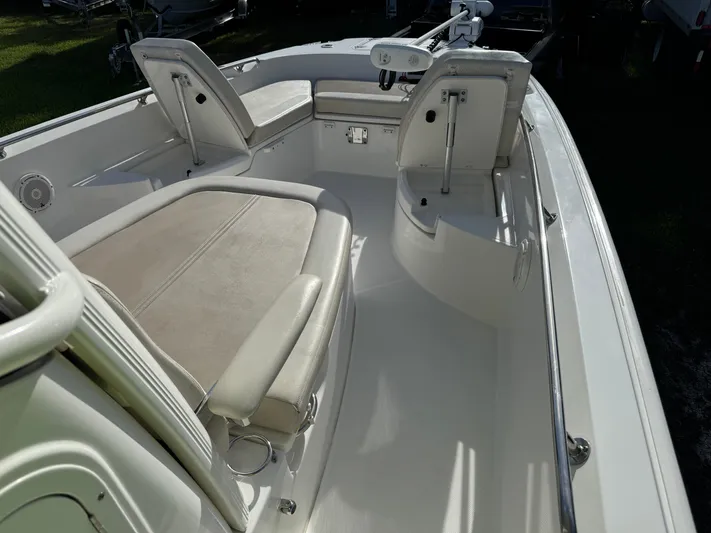  Yacht Photos Pics 2020 Boston Whaler 270 Dauntless boat interior with cushioned seating and steering console.