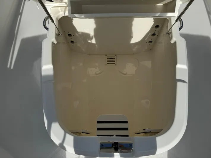  Yacht Photos Pics 2020 Boston Whaler 270 Dauntless storage compartment, open and empty, with sunlight casting shadows.