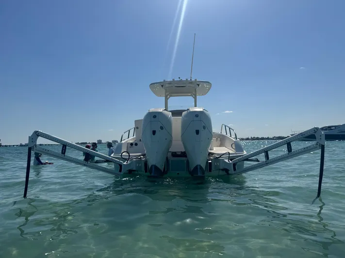  Yacht Photos Pics 2020 Boston Whaler 270 Dauntless boat on water, rear view with dual engines.