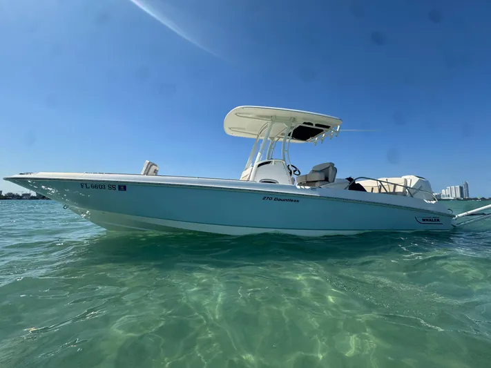  Yacht Photos Pics 2020 Boston Whaler 270 Dauntless boat on clear water under blue sky.