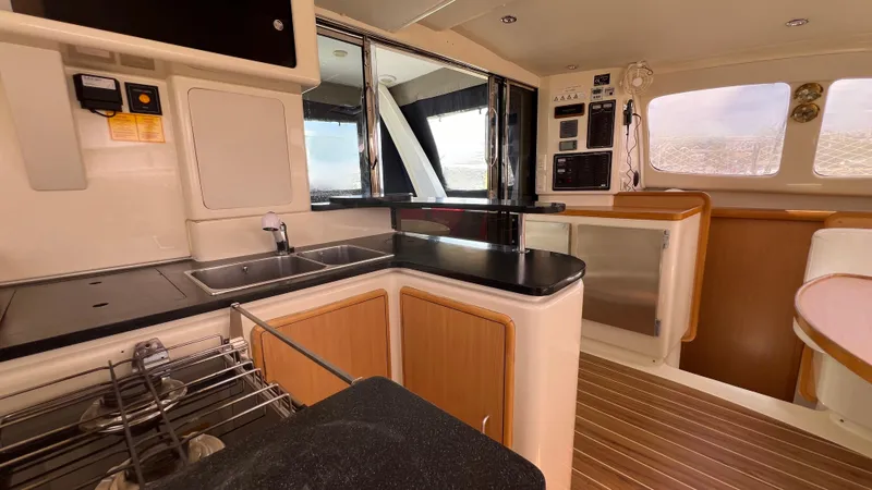 1687 Yacht Photos Pics Interior of 2006 Leopard 40 catamaran, featuring modern kitchen with wood accents and ample natural light.