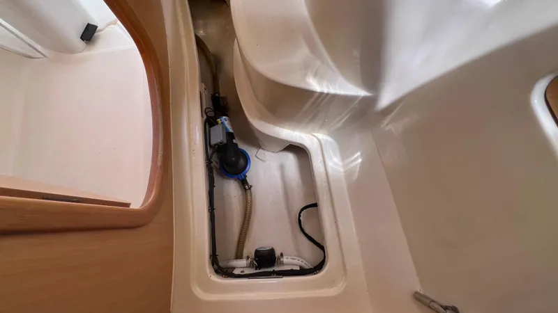 1687 Yacht Photos Pics Bilge compartment of a 2006 Leopard 40 catamaran, showing pump and hoses.