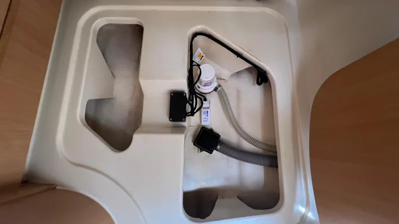 1687 Yacht Photos Pics Interior compartment of a 2006 Leopard 40 boat, showing wiring and tubing.