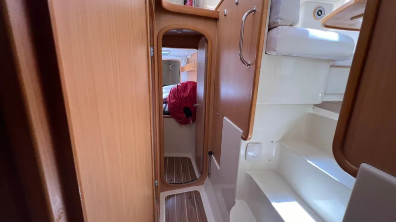 1687 Yacht Photos Pics Interior of a 2006 Leopard 40 catamaran, featuring wooden cabinetry and compact living space.