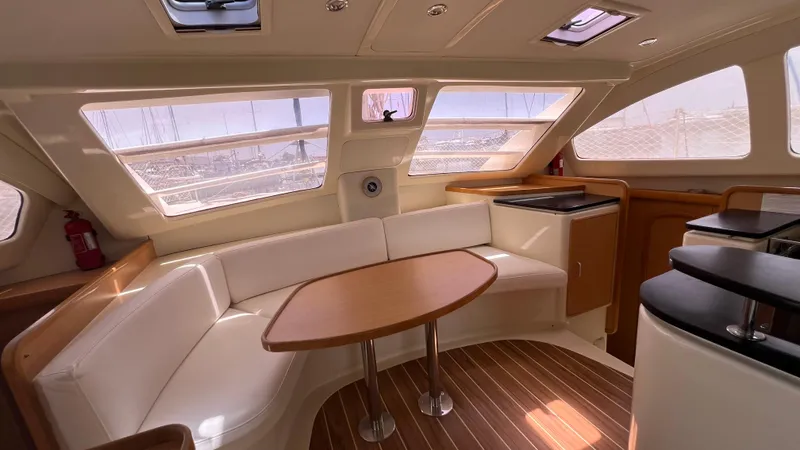 1687 Yacht Photos Pics Luxurious interior of a 2006 Leopard 40 catamaran with elegant seating and wooden accents.