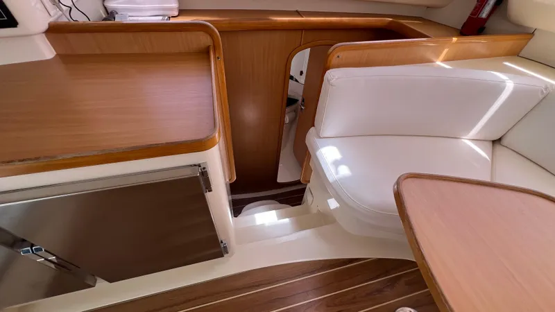 1687 Yacht Photos Pics Interior of a 2006 Leopard 40 catamaran with wood and white seating.