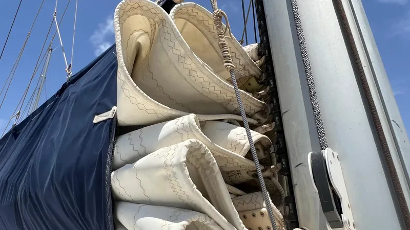 1687 Yacht Photos Pics Rolled sails on a 2006 Leopard 40 catamaran against a clear blue sky.