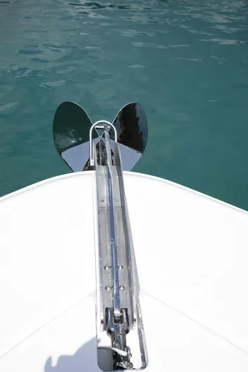 Bushwacked Yacht Photos Pics Bow view of 2025 HCB 56 Suenos GIX yacht with anchor over clear water.