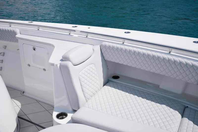 Bushwacked Yacht Photos Pics Luxurious seating on 2025 HCB 56 Suenos GIX boat with quilted white upholstery.