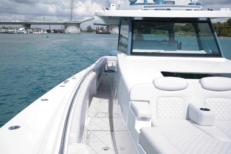 Bushwacked Yacht Photos Pics 2025 HCB 56 Suenos GIX luxury boat on water near a bridge.