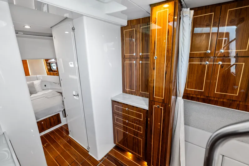 Bushwacked Yacht Photos Pics Luxurious interior of 2025 HCB 56 Suenos GIX yacht with elegant wood cabinetry.