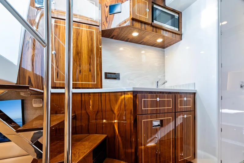 Bushwacked Yacht Photos Pics Luxurious interior of 2025 HCB 56 Suenos GIX yacht with elegant wood cabinetry.
