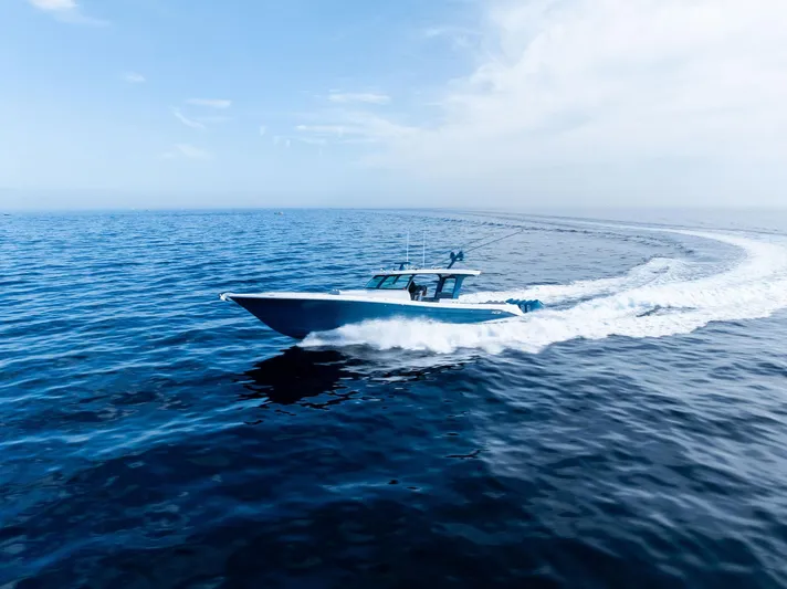 Bushwacked Yacht Photos Pics 2025 HCB 56 Suenos GIX cruising on open ocean under clear blue sky.