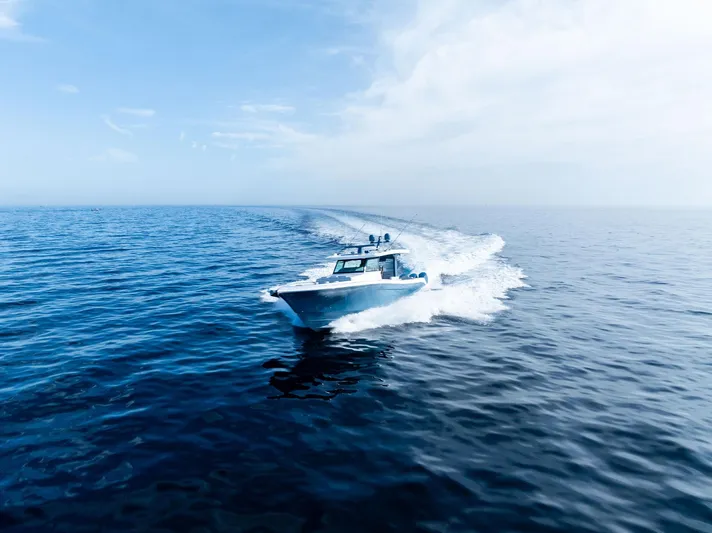 Bushwacked Yacht Photos Pics 2025 HCB 56 Suenos GIX cruising on open ocean under clear blue sky.