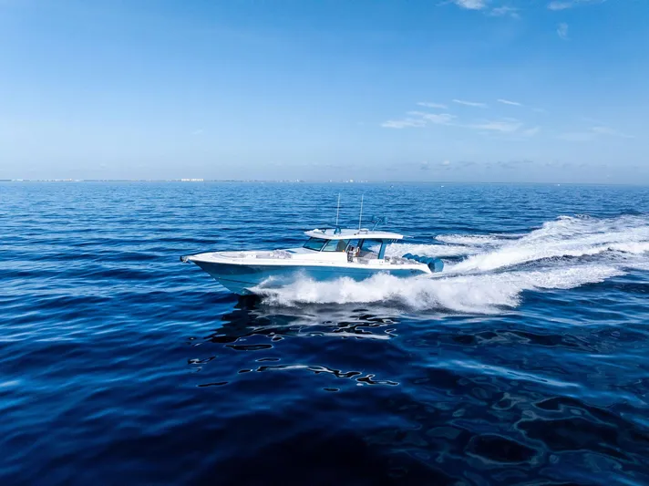 Bushwacked Yacht Photos Pics 2025 HCB 56 Suenos GIX cruising on open ocean under clear blue sky.