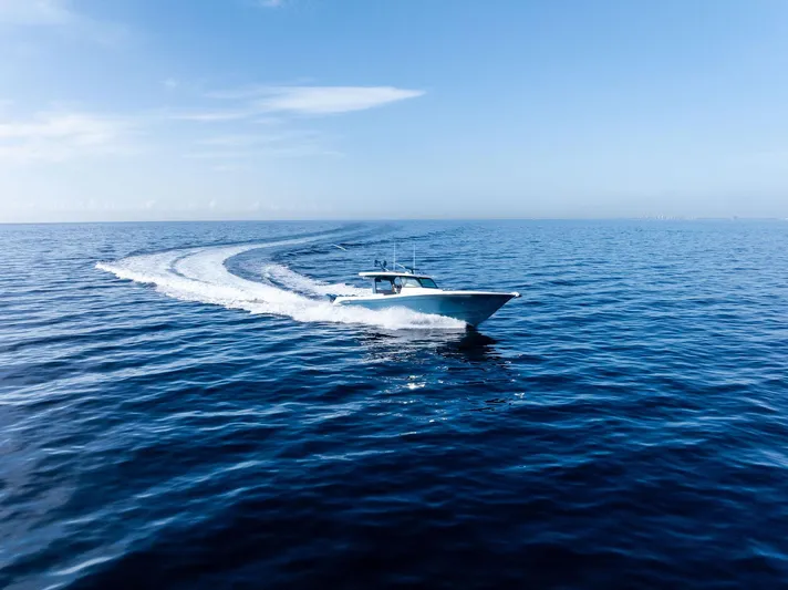 Bushwacked Yacht Photos Pics 2025 HCB 56 Suenos GIX cruising on open ocean under clear blue sky.