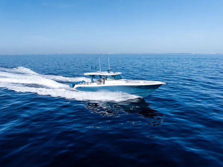 Bushwacked Yacht Photos Pics 2025 HCB 56 Suenos GIX cruising on open ocean under clear blue sky.