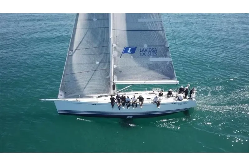 Arya Yacht Photos Pics 2010 X Yachts x-50 sailboat with crew sailing on open water.