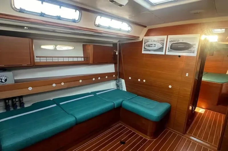 Arya Yacht Photos Pics Interior of 2010 X Yachts X-50 with wooden finish and teal seating.