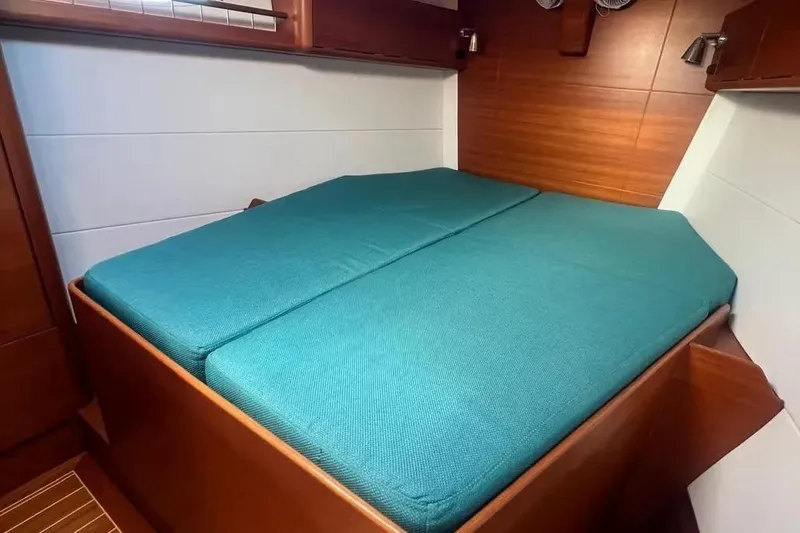 Arya Yacht Photos Pics Cozy cabin interior of 2010 X Yachts X-50 with teal bedding.