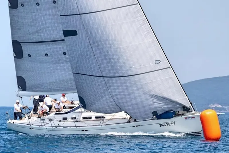 Arya Yacht Photos Pics 2010 X Yachts X-50 sailboat racing on open water with crew onboard.