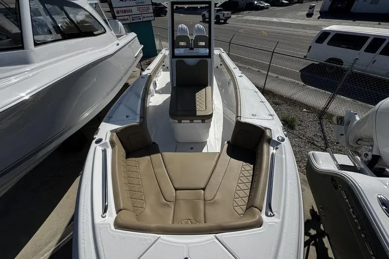  Yacht Photos Pics 2026 Blazer Bay Makaira 2800 boat with tan seating, docked outdoors.