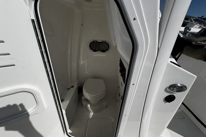  Yacht Photos Pics 2026 Blazer Bay Makaira 2800 boat interior with compact marine toilet.