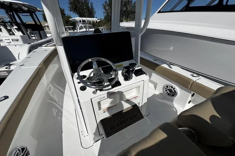  Yacht Photos Pics 2026 Blazer Bay Makaira 2800 boat cockpit with steering wheel and controls.