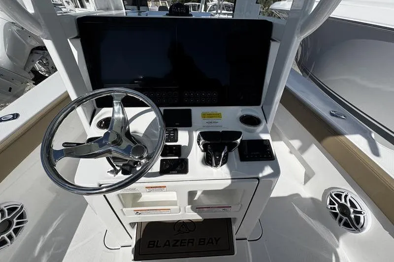  Yacht Photos Pics 2026 Blazer Bay Makaira 2800 boat helm with steering wheel and control panel.